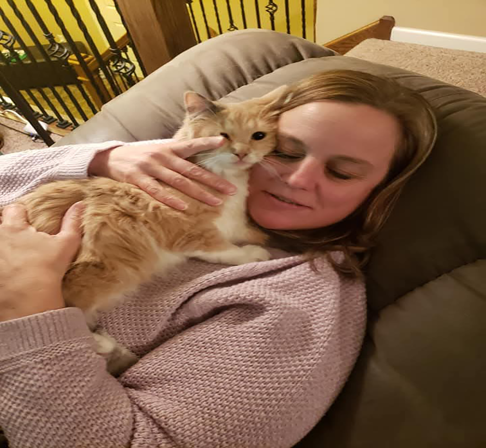 Leia and Jen snuggling Author Dave's wife Jen holds their kitty on their couch for a snuggle.
