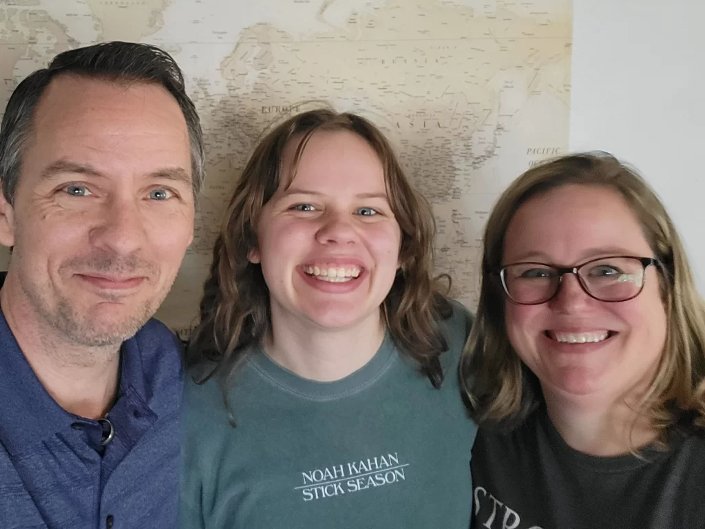 From left to right, Author Dave, then daughter Ashley, with wife Jen all smiling brightly at the camera for a selfie.