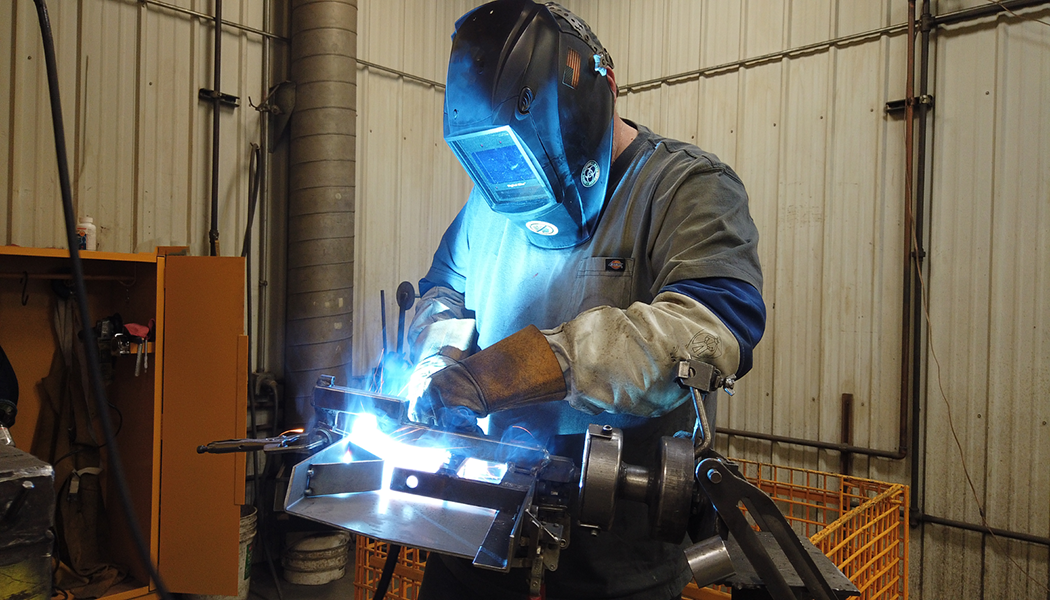 Employee works on building a computer highlighting manufacturing jobs in Grand Forks, ND