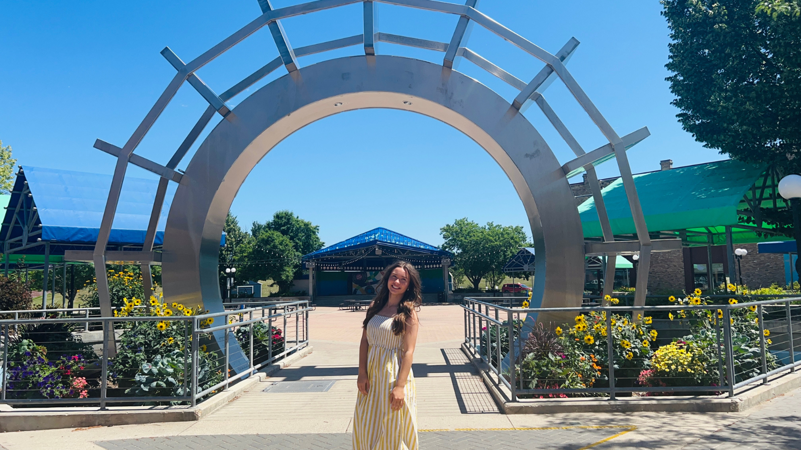 Author Natalie poses under the townsquare arch in Grand Forks