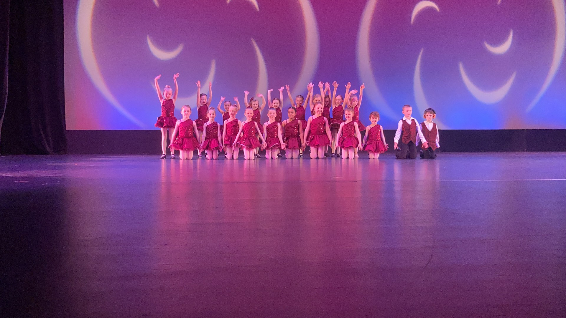 Author Natalie is shown dancing in a group as a child up on stage.