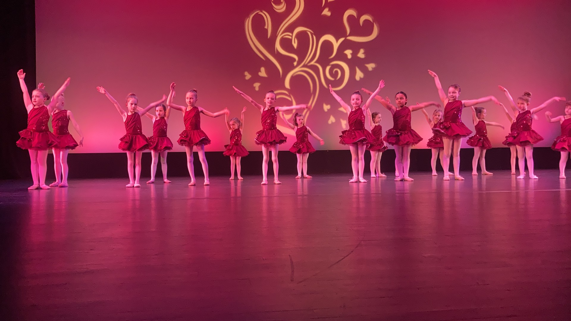 Author Natalie is shown dancing in a group as a child up on stage.