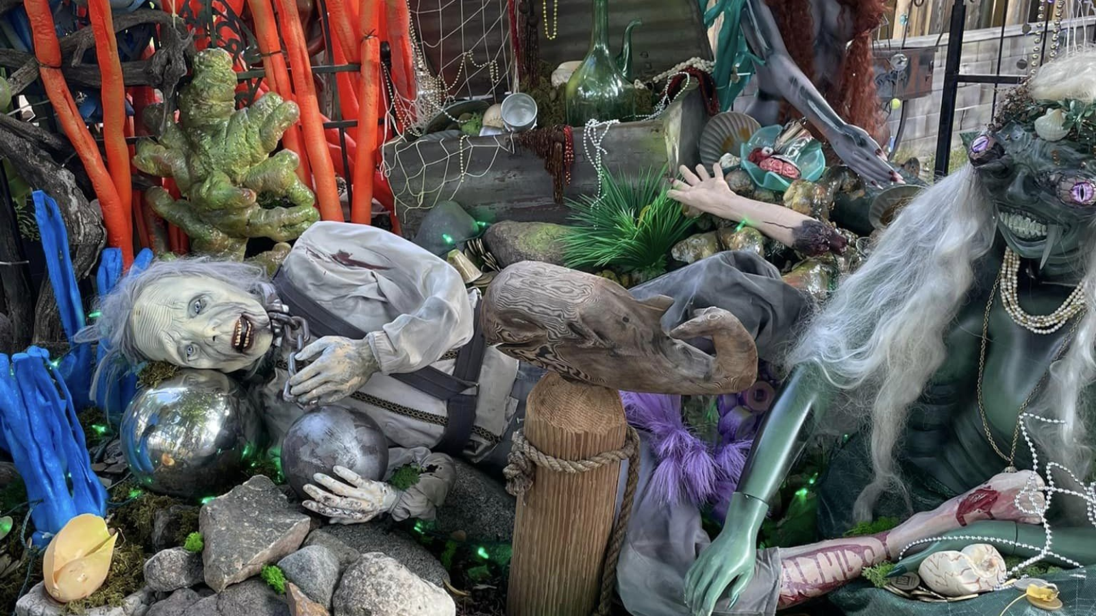 Halloween decorations depicting mermaids, their victim, a treasure chest, and a seascape.