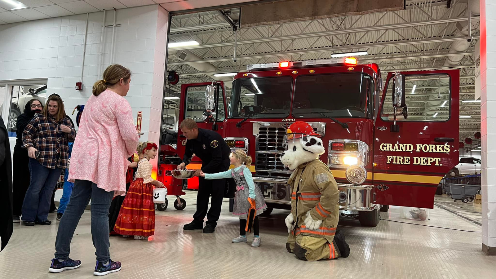 Trunk of Treat at the Fire Station photo! The dalmation mascot for the fire station hands out candy for kiddos dressed up for Halloween!