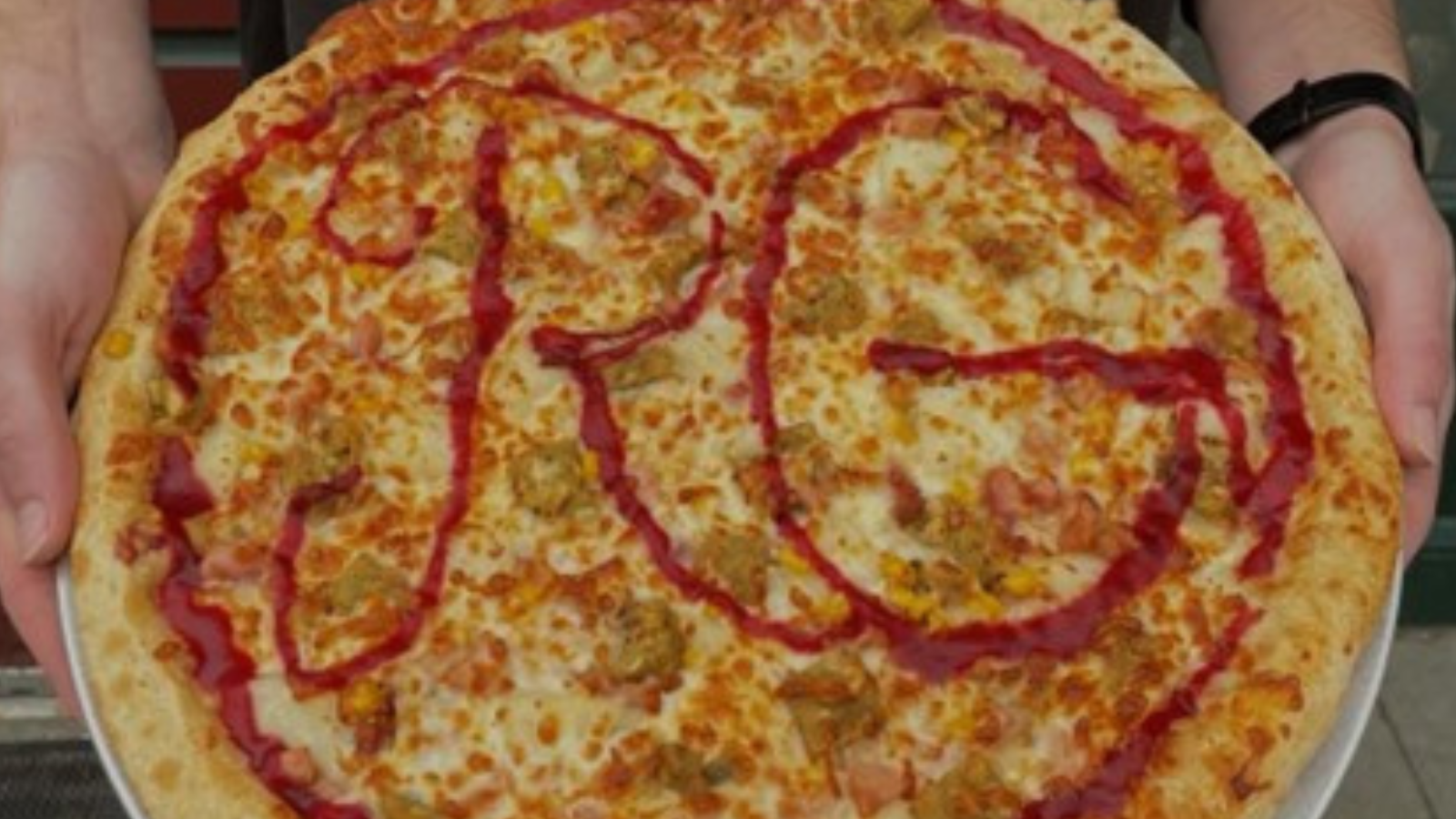Rhombus Guys close up of a yummy pizza with their RG letters spelled out across the pie!