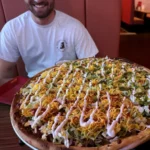 A big taco pizza is displayed right up in front of the camera!