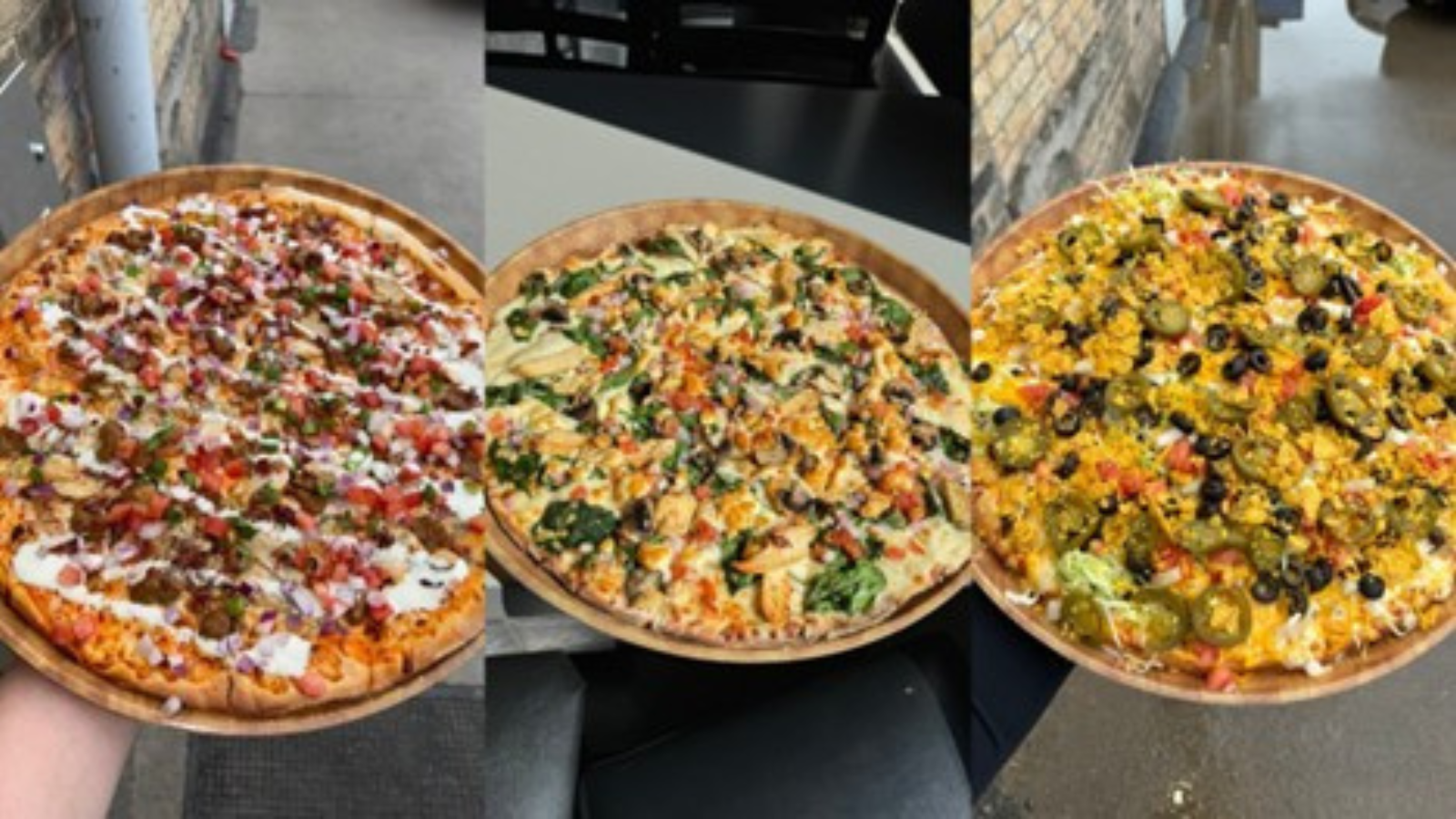 Joe Black's pizza display. Three different small size pizzas lined up next to each other for the camera.