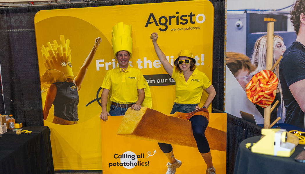 Two Agristo employees pose with their banner at the annual Northern Valley Career Expo