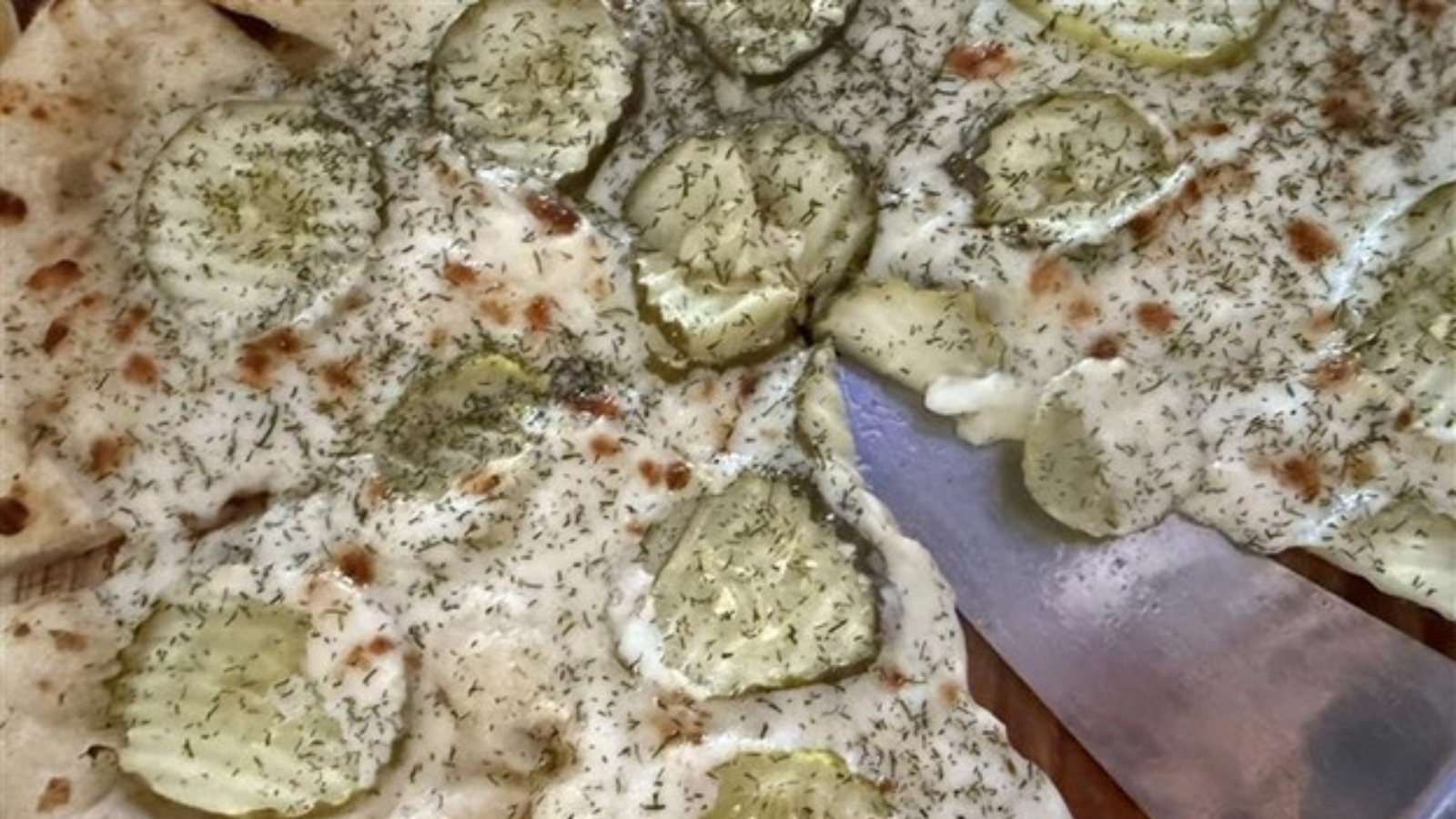 Close up shot of UpNorth pickle pizza that looks oh so flavorful!