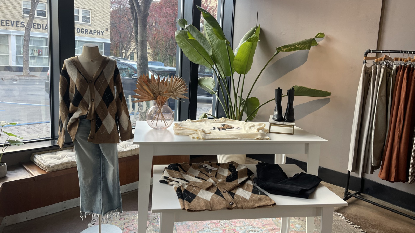 Pretty B Boutique photo of one of their displays. A mannequin with a preppy argyle sweater on and nice wide fit jeans.