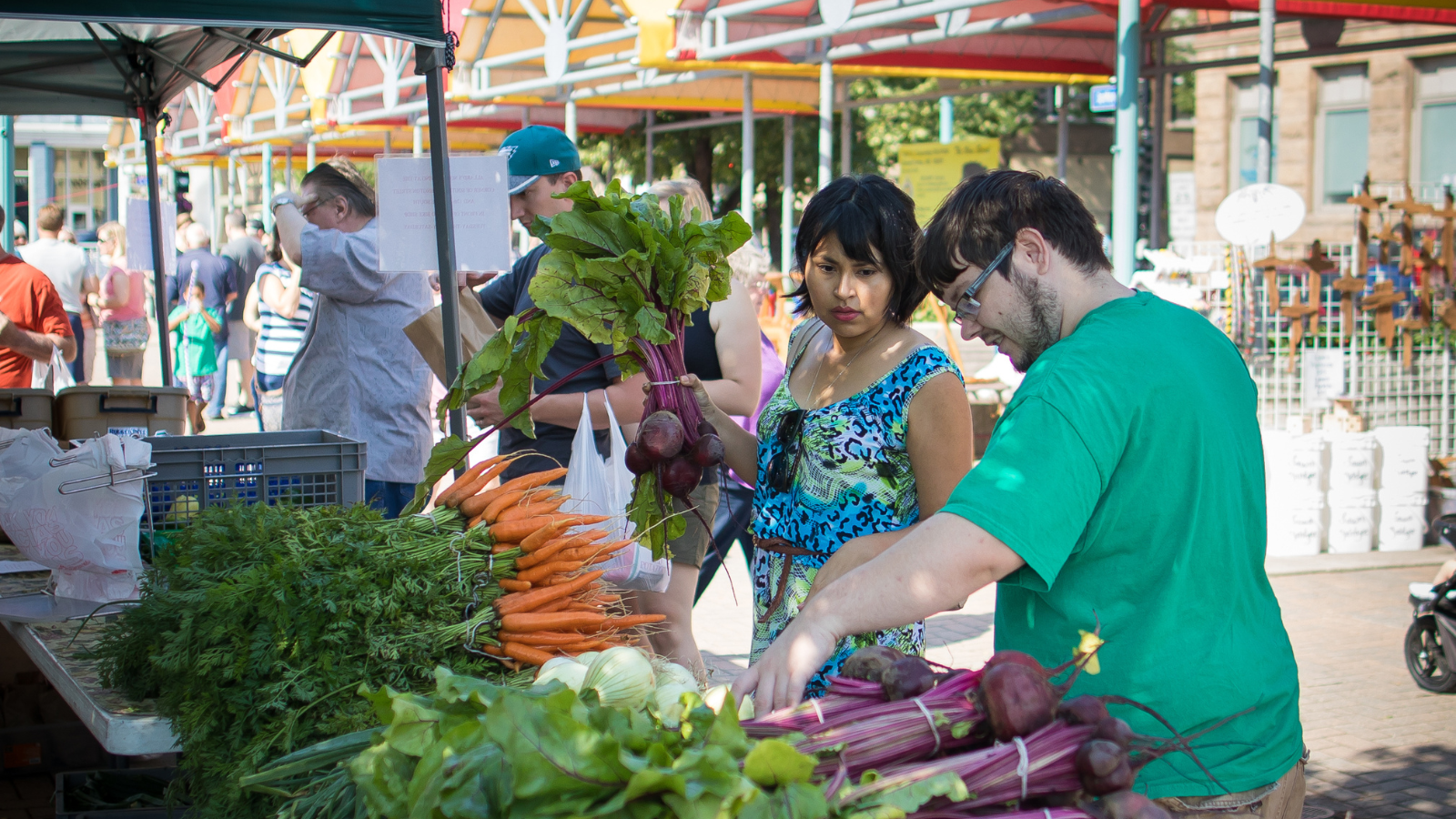 Farmer's Market Photo two people picking out fresh veggies