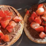 A close up shot of a Nutella and strawberry bagels!
