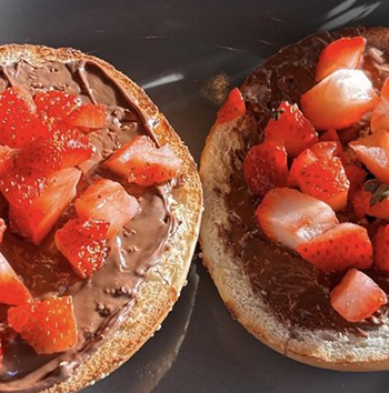 A close up shot of a Nutella and strawberry bagels!