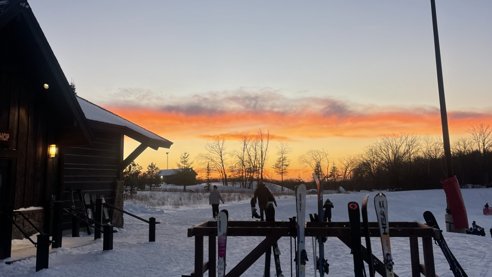 Detroit Mountain Sunset Picture shows part of the Detroit Mountain lodge and ski racks with the sunset in the background on a beautiful January day.