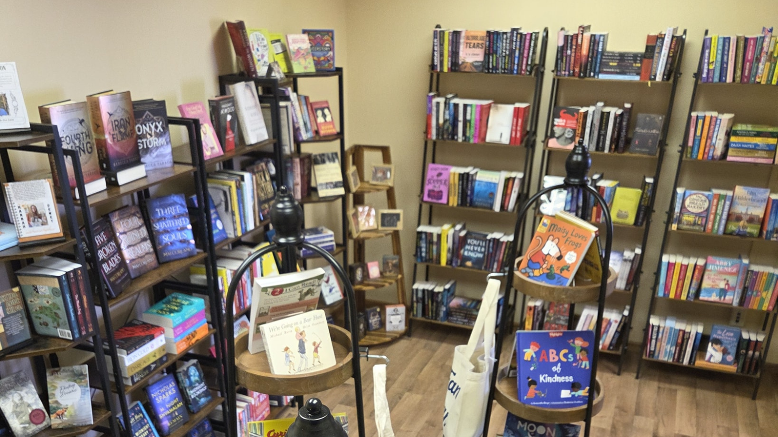Bookstore photo from up high showing tall shelves stocked full with good books!
