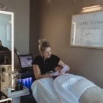 Carly Irene Artistry works on a client in her suite