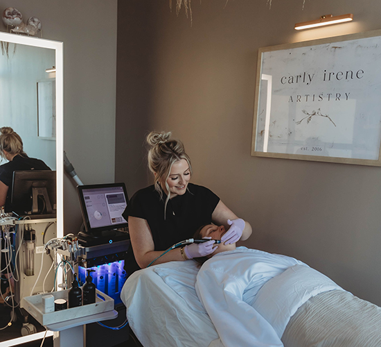 Carly Irene Artistry works on a client in her suite