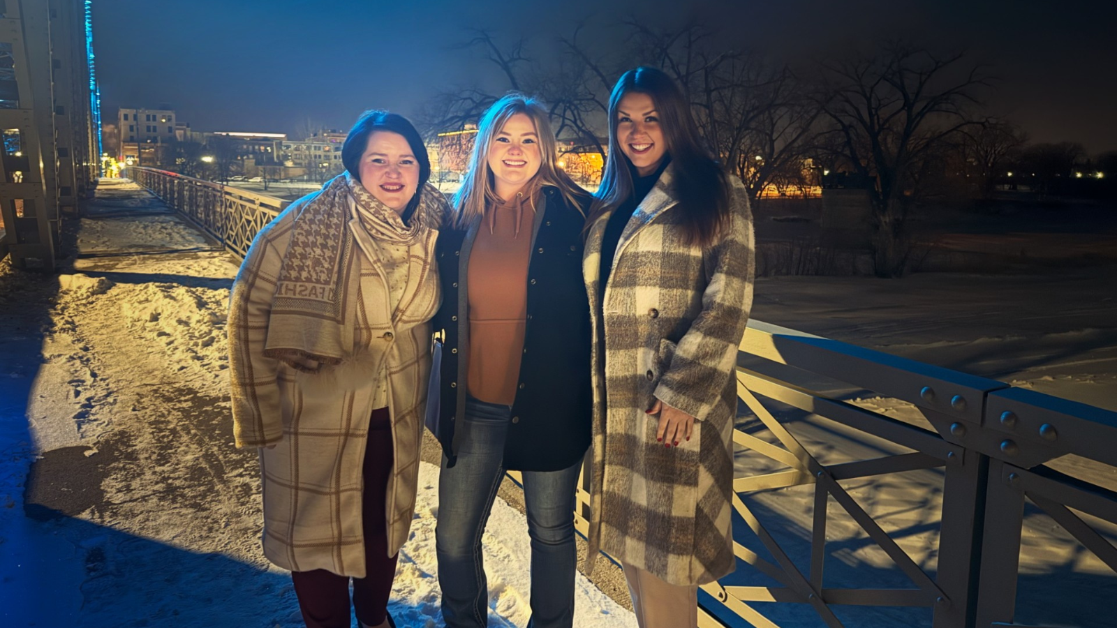 Group Photo after Dinner Becca, Emma, and Sydney stand together on the Grand Forks Bridge after having dinner together.