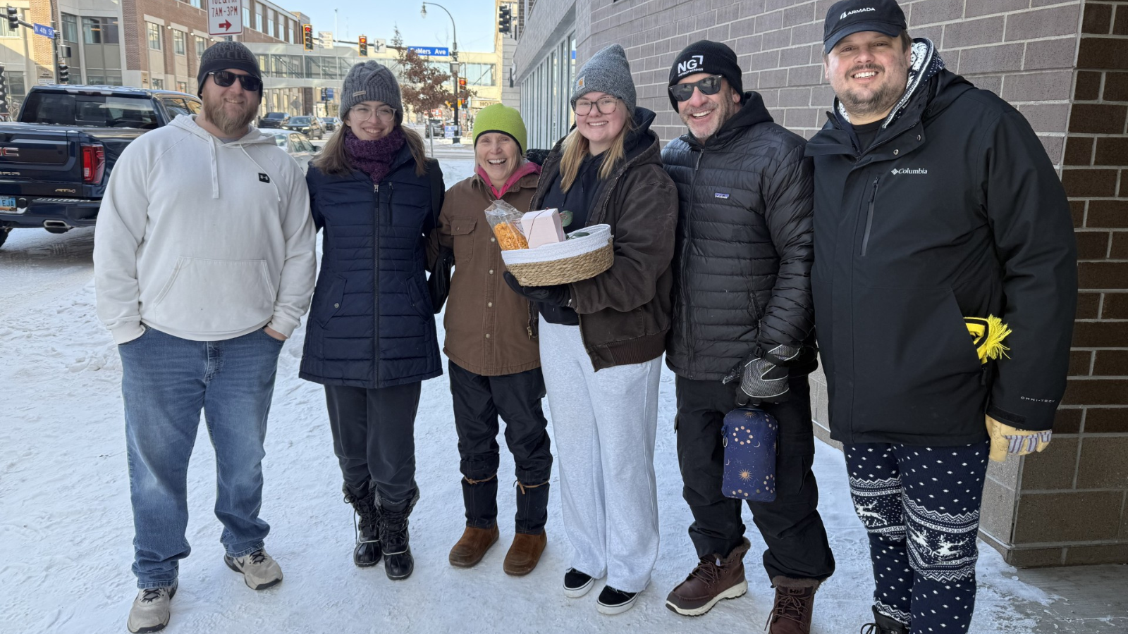 Moving Crew Photo The moving crew stands with Emma and her welcome gift outside her new apartment complex!