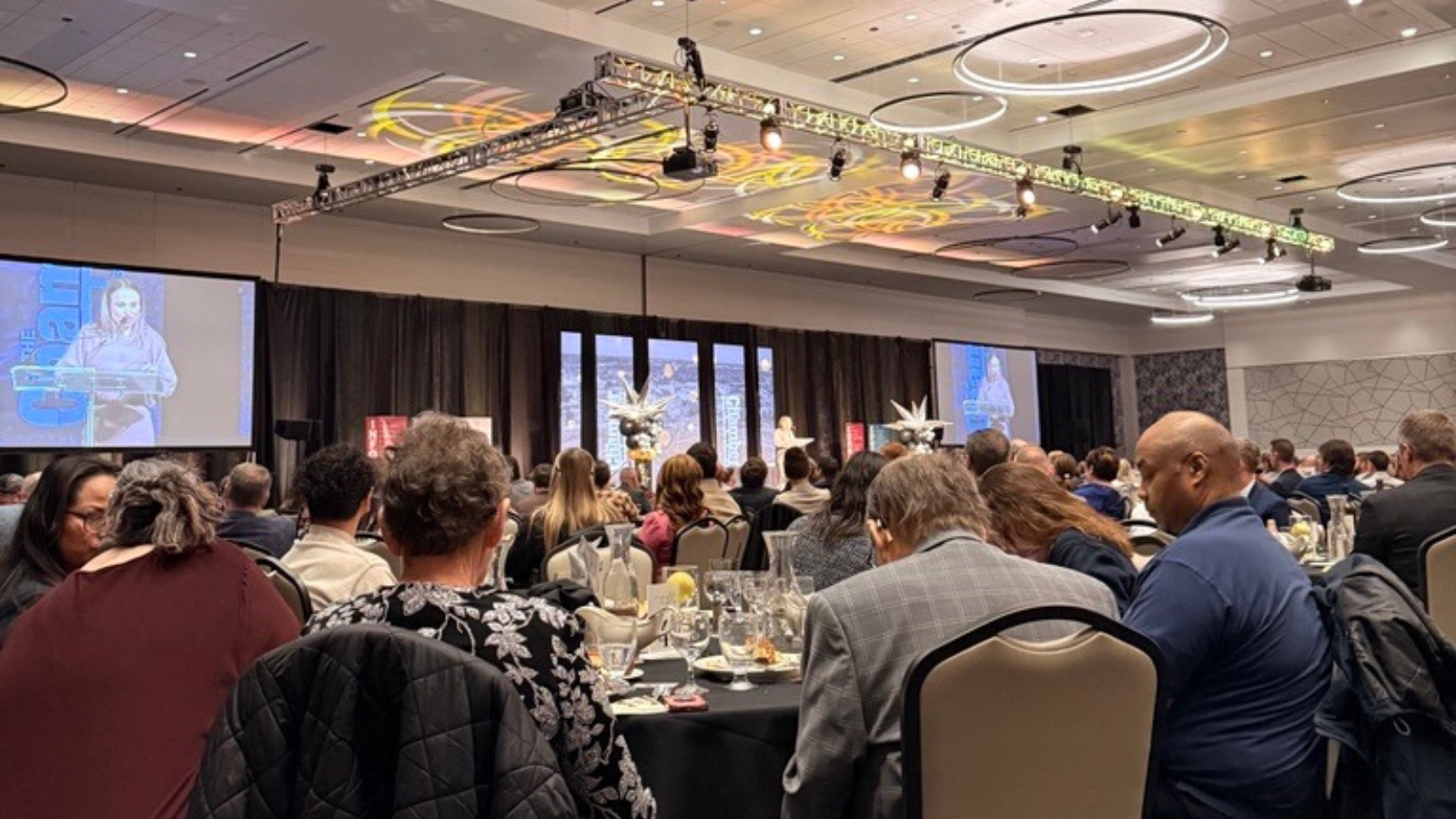 Chamber Annual Event Image showing the stage and everyone sitting around the chairs