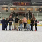 A group of ggfyp members stand together on the ice at the EGF Civic Center for the annual broomball session!