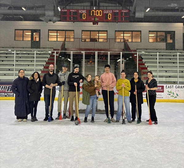 A group of ggfyp members stand together on the ice at the EGF Civic Center for the annual broomball session!