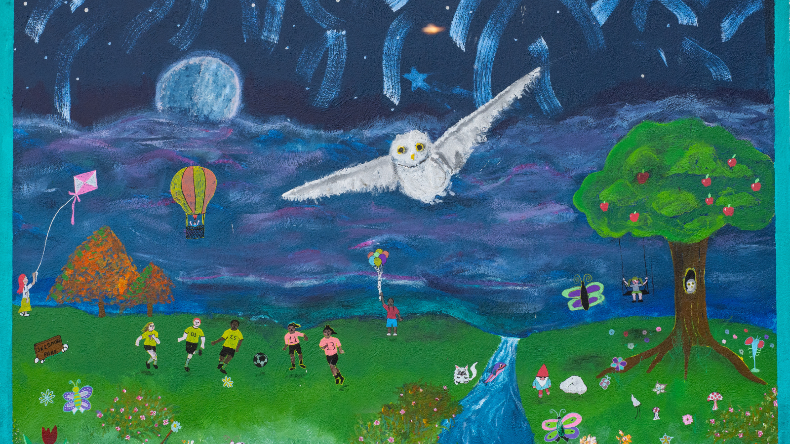 Mural Photo Beautiful mural in Grand Forks with a night sky over the water and green fields with a white owl flying in the center