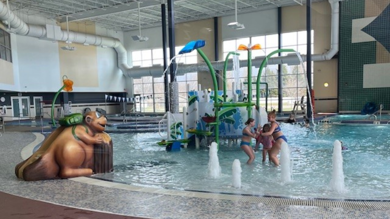 Choice Fitness splash pad with folks swimming in the water